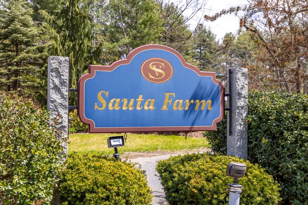 31 Sauta Farm Way, Unit 16 Hudson, MA 01749 - Photo 40 of 41 a sign that is sitting on a brick wall