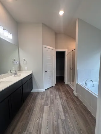 a spacious bathroom with a double vanity sink and a mirror