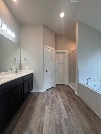 a bathroom with a double vanity sink and mirror