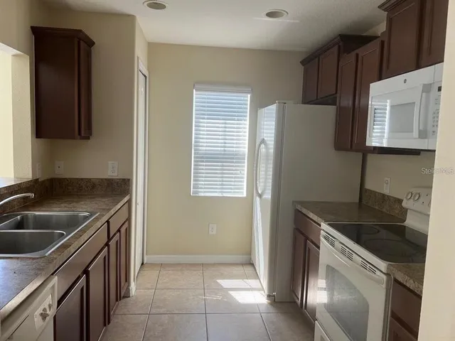 a kitchen that has a sink and a stove