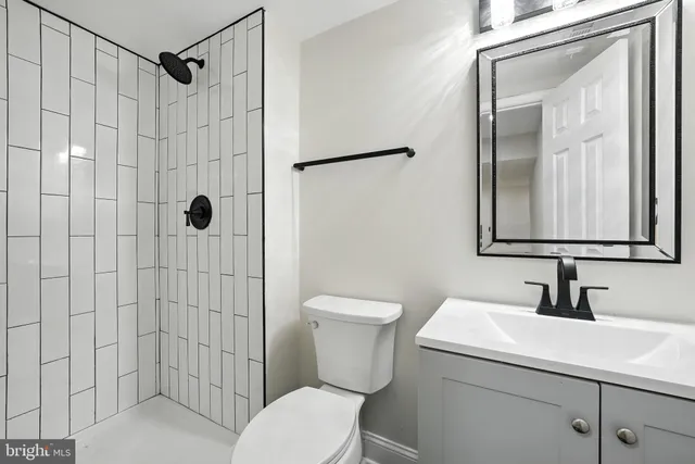 a bathroom with a toilet sink and shower