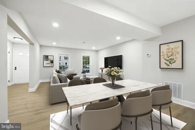 a living room with furniture wooden floor and a flat screen tv