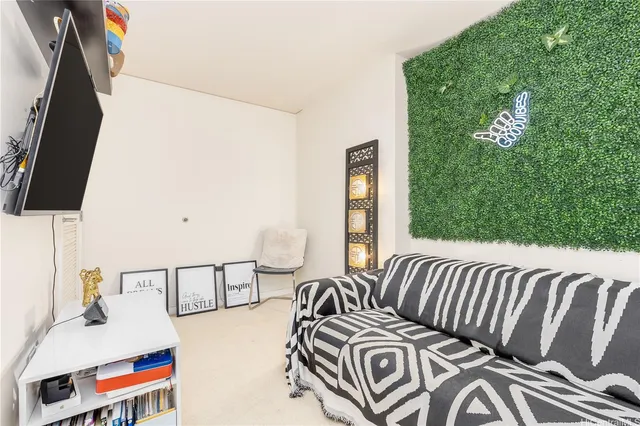 a bedroom with a bed and a painting on the wall