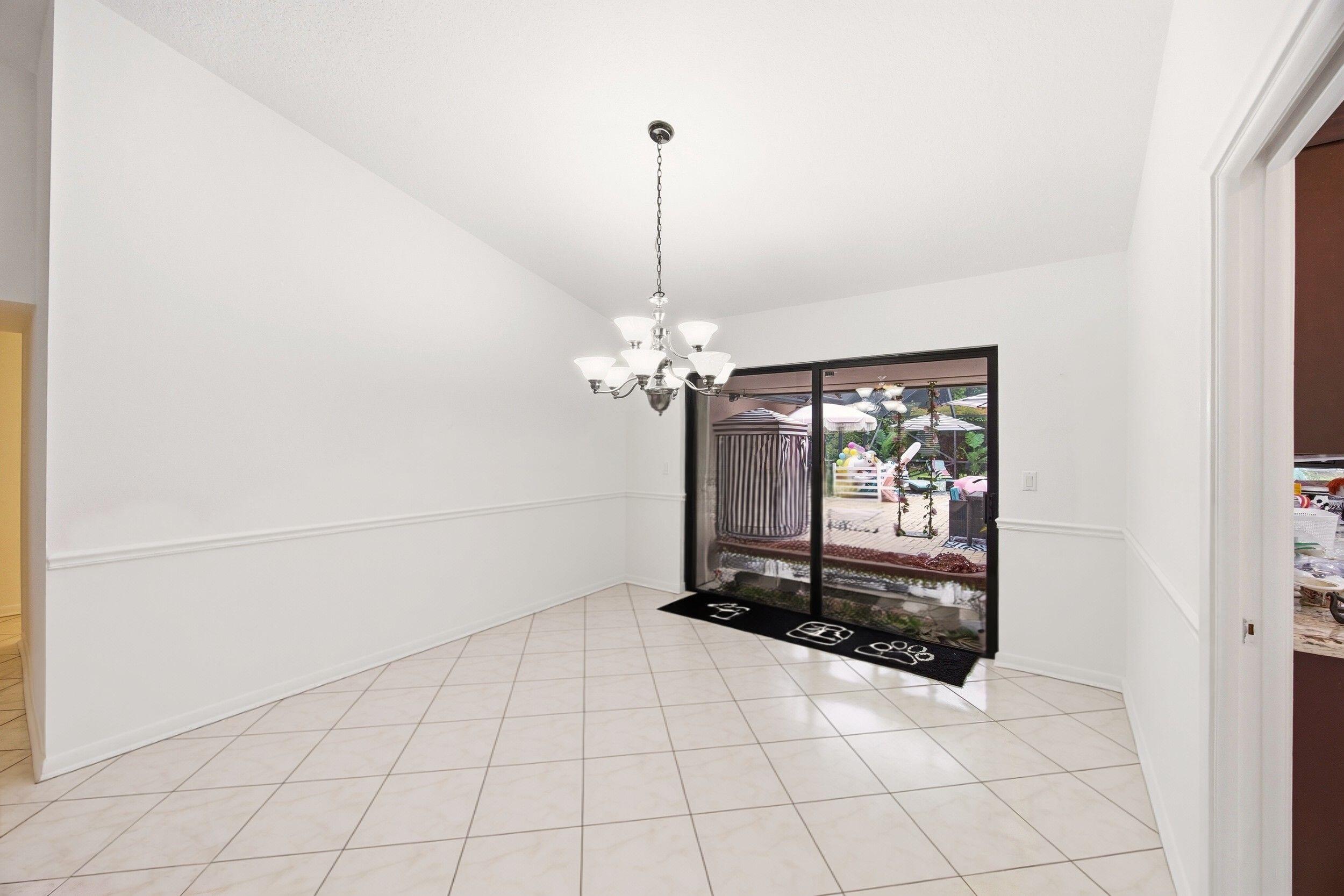 375 Northwest 53rd Street Boca Raton, FL 33487 - Photo 11 of 14 a dining room filled with furniture and a chandelier