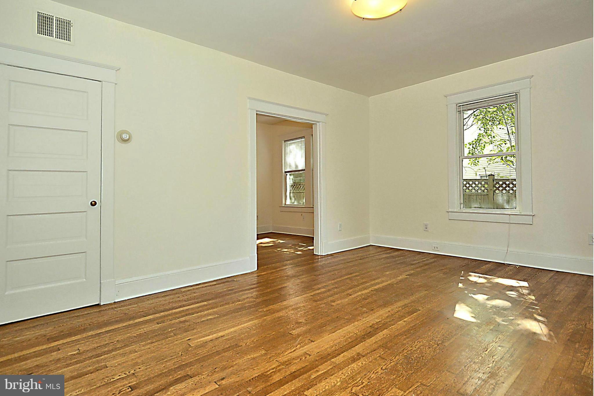 4319 River Road Northwest Washington, DC 20016 - Photo 9 of 22 a view of an empty room with wooden floor and a window