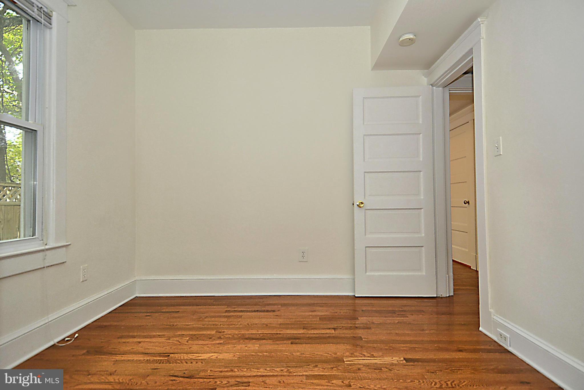 4319 River Road Northwest Washington, DC 20016 - Photo 10 of 22 a view of an empty room with wooden floor and a window