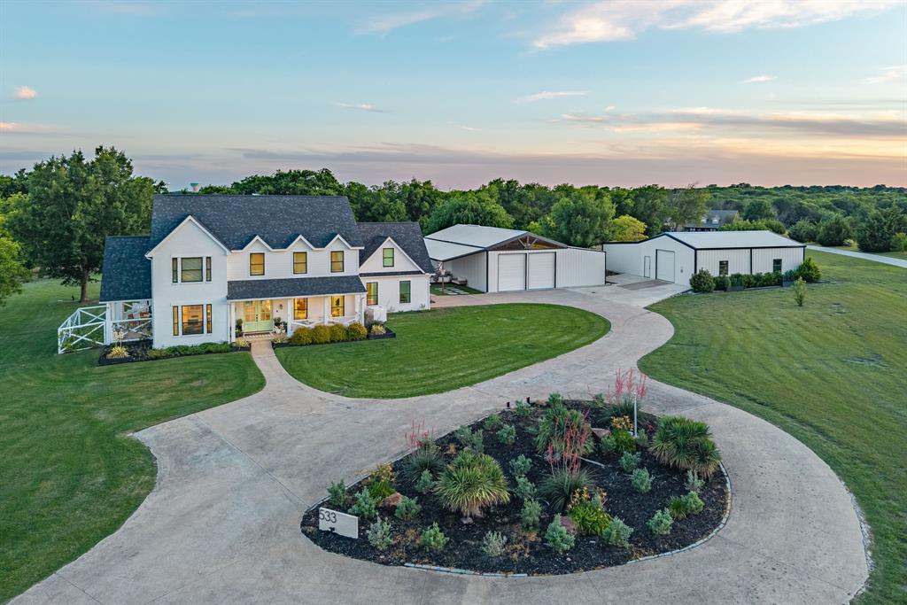 533 Camp Creek Road Rockwall, TX 75087 - Photo 2 of 38 Expansive property featuring a white two-story residence and two detached outbuildings
