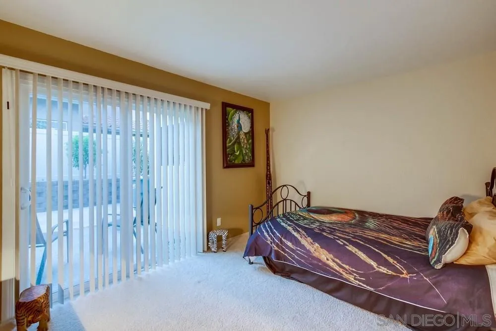 13952 Carriage Road Poway, CA 92064 - Photo 34 of 49 a bedroom with a bed and wooden floor