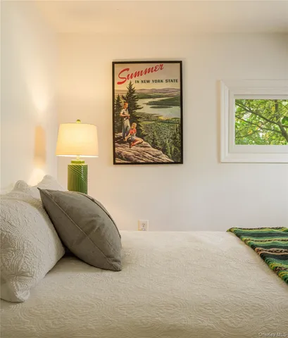 a bedroom with a bed and a painting on the wall