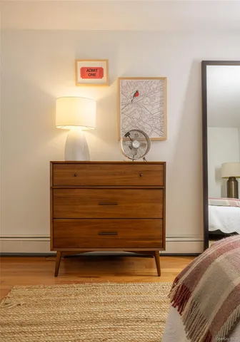 a bedroom with a bed and painting on the wall