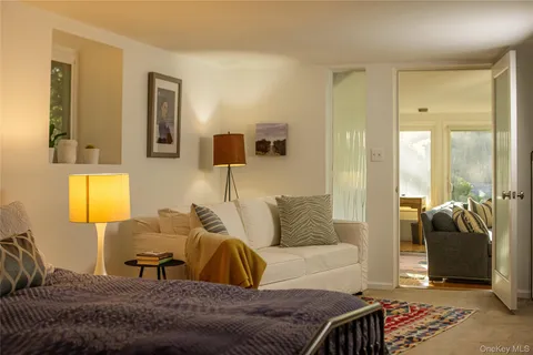 a living room with furniture and a lamp