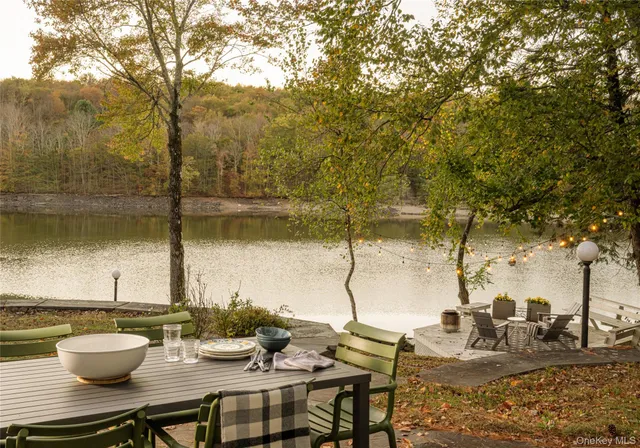 a view of a lake with couches and wooden floor