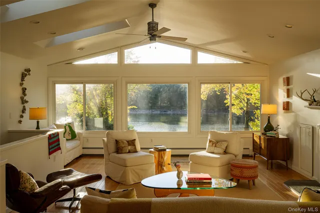 a living room with fireplace furniture and a large window