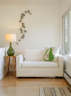 a living room with a couch and a potted plant