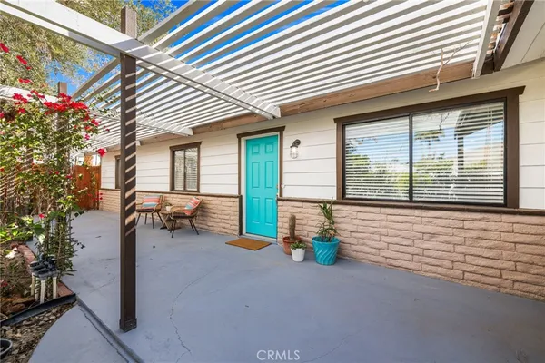 a view of a house with a yard porch and sitting area