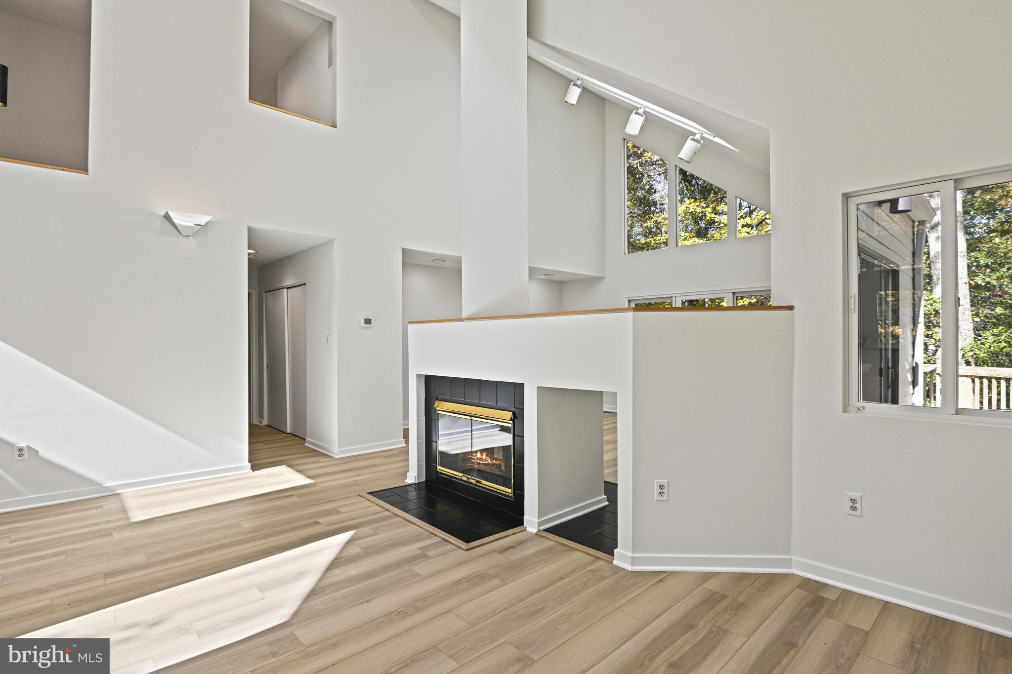 11504 Turnbridge Lane Reston, VA 20194 - Photo 13 of 51 a view of an empty room with window and wooden floor
