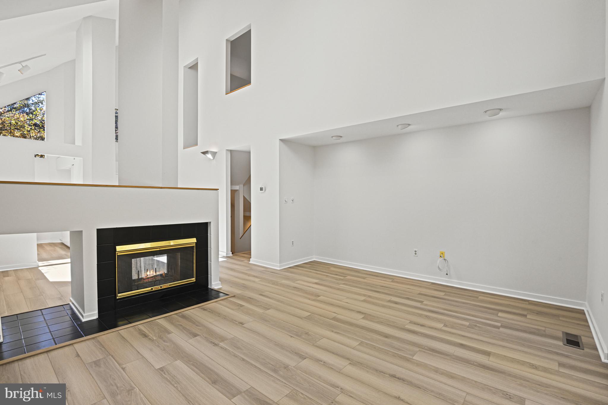 11504 Turnbridge Lane Reston, VA 20194 - Photo 20 of 51 a view of an empty room with wooden floor and fireplace