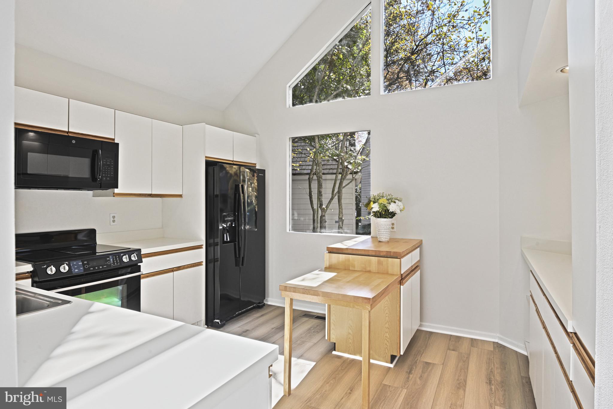 11504 Turnbridge Lane Reston, VA 20194 - Photo 7 of 51 a kitchen with a refrigerator and a stove top oven
