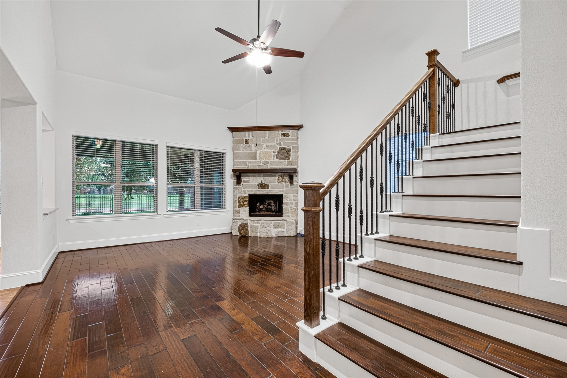 7930 Summer Night Lane Rosenberg, TX 77469 - Photo 10 of 48 Spacious living room featuring high ceilings, a fireplace, and an open staircase.