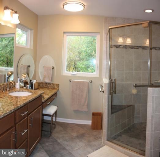 3742 Hope Commons Circle Frederick, MD 21704 - Photo 1 of 17 a bathroom with a granite countertop sink a mirror and shower