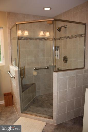 3742 Hope Commons Circle Frederick, MD 21704 - Photo 2 of 17 a bathroom with a glass shower door