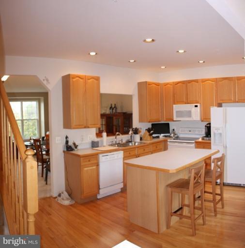 3742 Hope Commons Circle Frederick, MD 21704 - Photo 15 of 17 a kitchen with stainless steel appliances kitchen island granite countertop a sink and a refrigerator