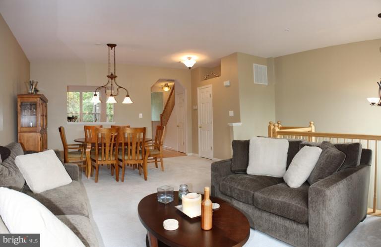 3742 Hope Commons Circle Frederick, MD 21704 - Photo 9 of 17 a living room with furniture and a chandelier