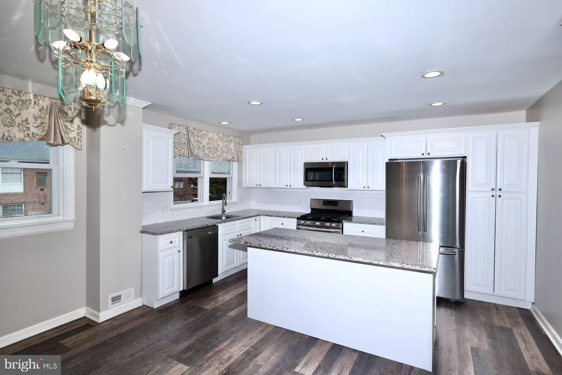11850 Basile Road Philadelphia, PA 19154 - Photo 11 of 31 a kitchen with stainless steel appliances granite countertop a refrigerator a stove a sink dishwasher and a refrigerator with wooden floor