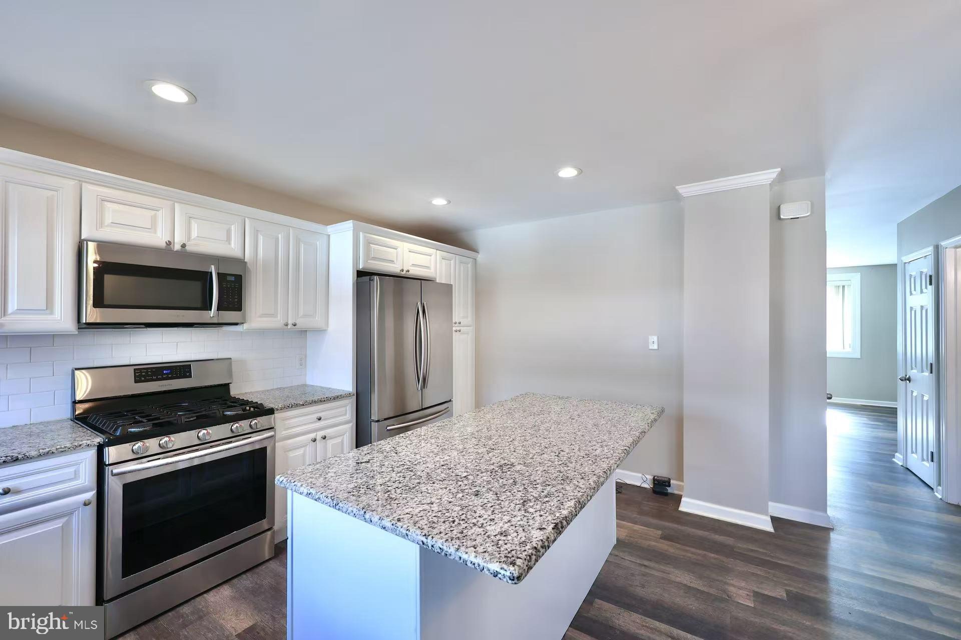 11850 Basile Road Philadelphia, PA 19154 - Photo 8 of 31 a kitchen with stainless steel appliances kitchen island granite countertop a stove and a wooden floors