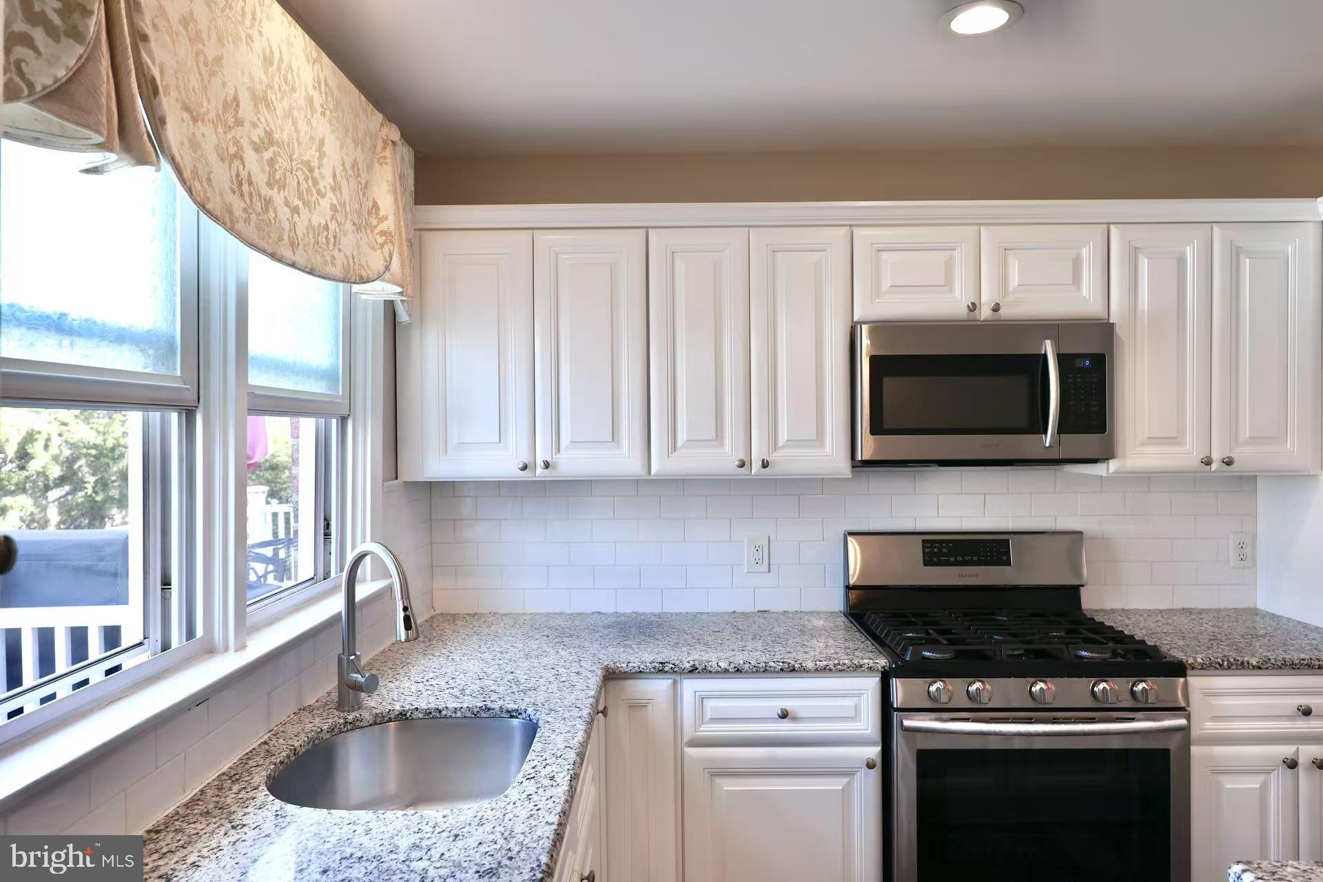 11850 Basile Road Philadelphia, PA 19154 - Photo 9 of 31 a kitchen with stainless steel appliances granite countertop a sink stove and microwave