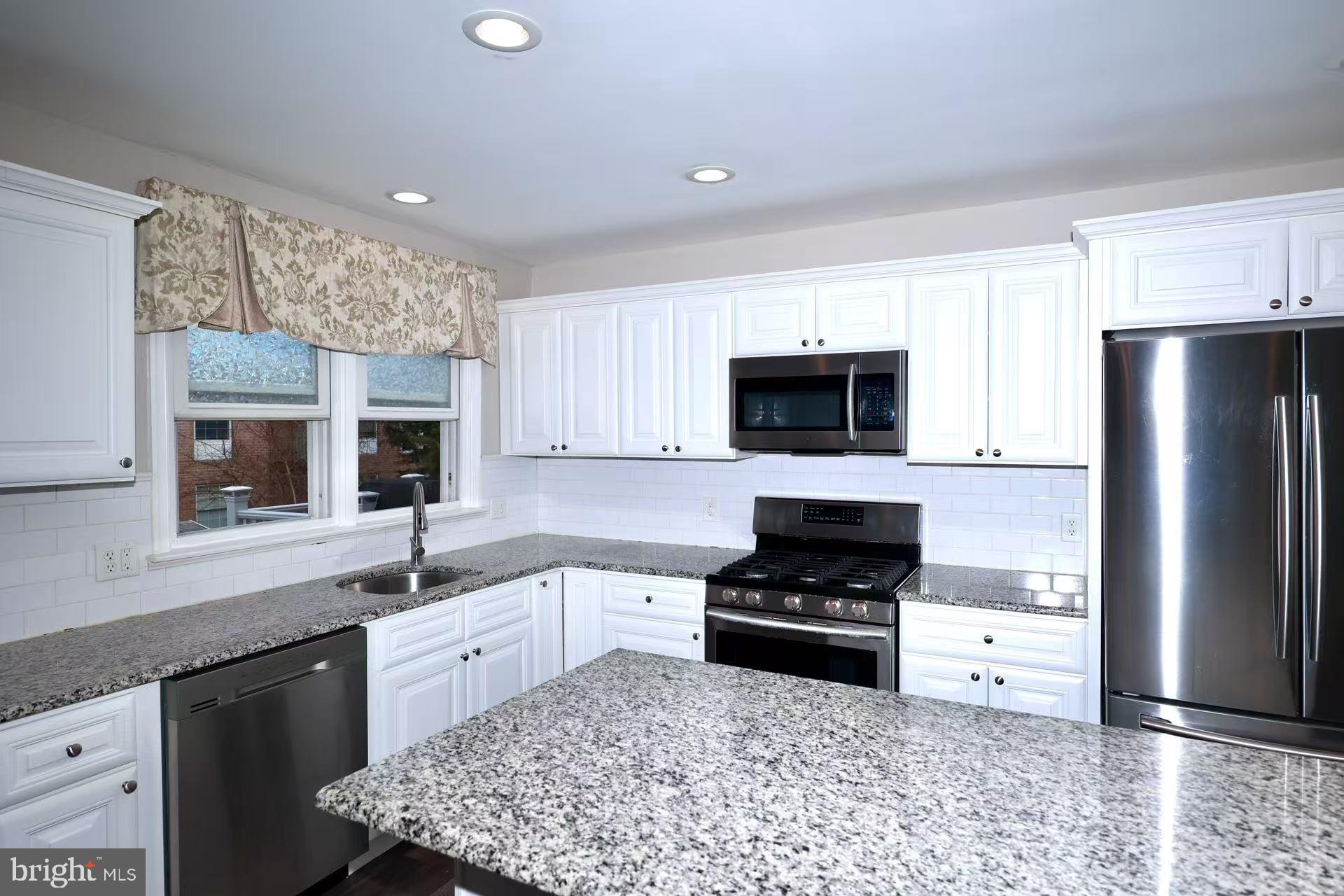 11850 Basile Road Philadelphia, PA 19154 - Photo 10 of 31 a kitchen with a sink stainless steel appliances and cabinets