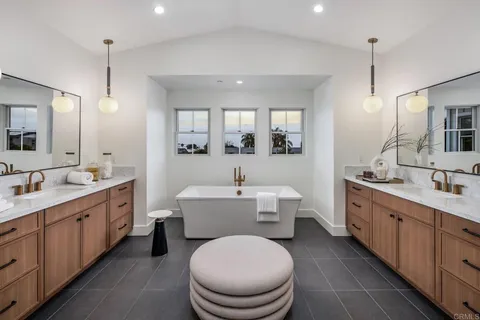 a bathroom with a toilet a sink a mirror a vanity and bathtub