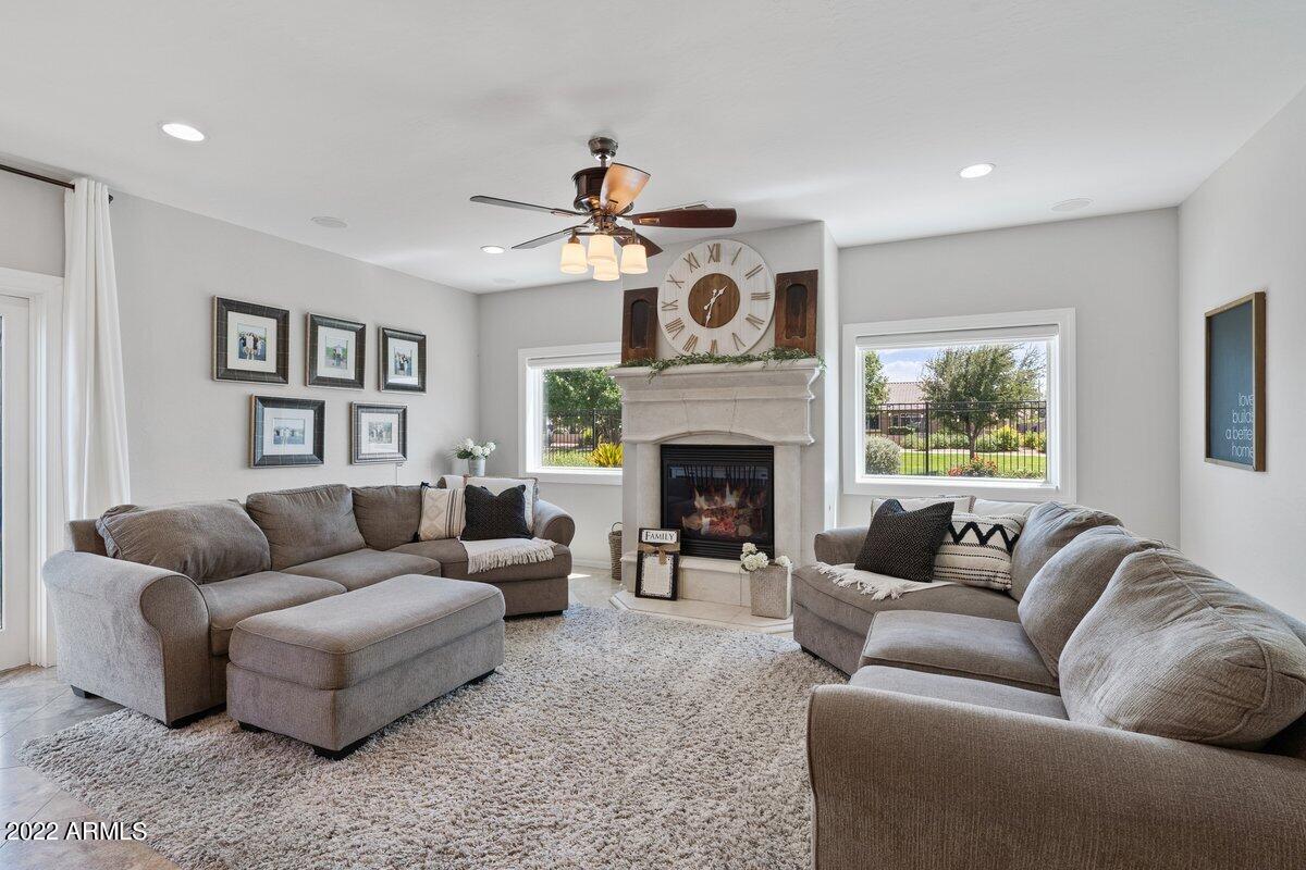 21973 East Rosa Road Queen Creek, AZ 85142 - Photo 6 of 15 a living room with furniture and a fireplace