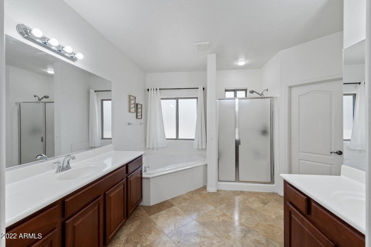 21973 East Rosa Road Queen Creek, AZ 85142 - Photo 8 of 15 a bathroom with a sink double vanity granite tub shower and a mirror