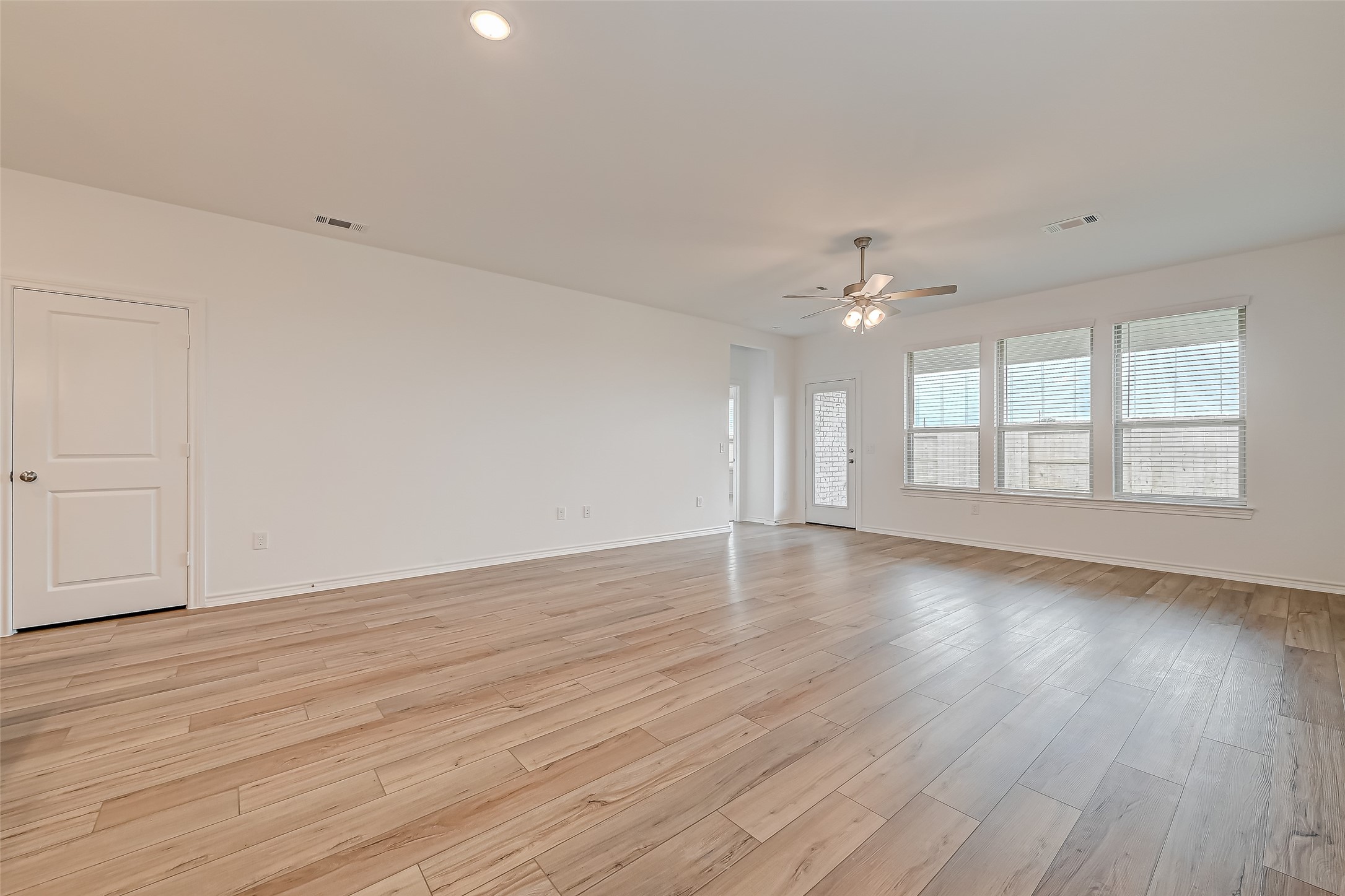 1308 Tan Gable Lane Katy, TX 77493 - Photo 6 of 30 a view of an empty room with wooden floor and a window