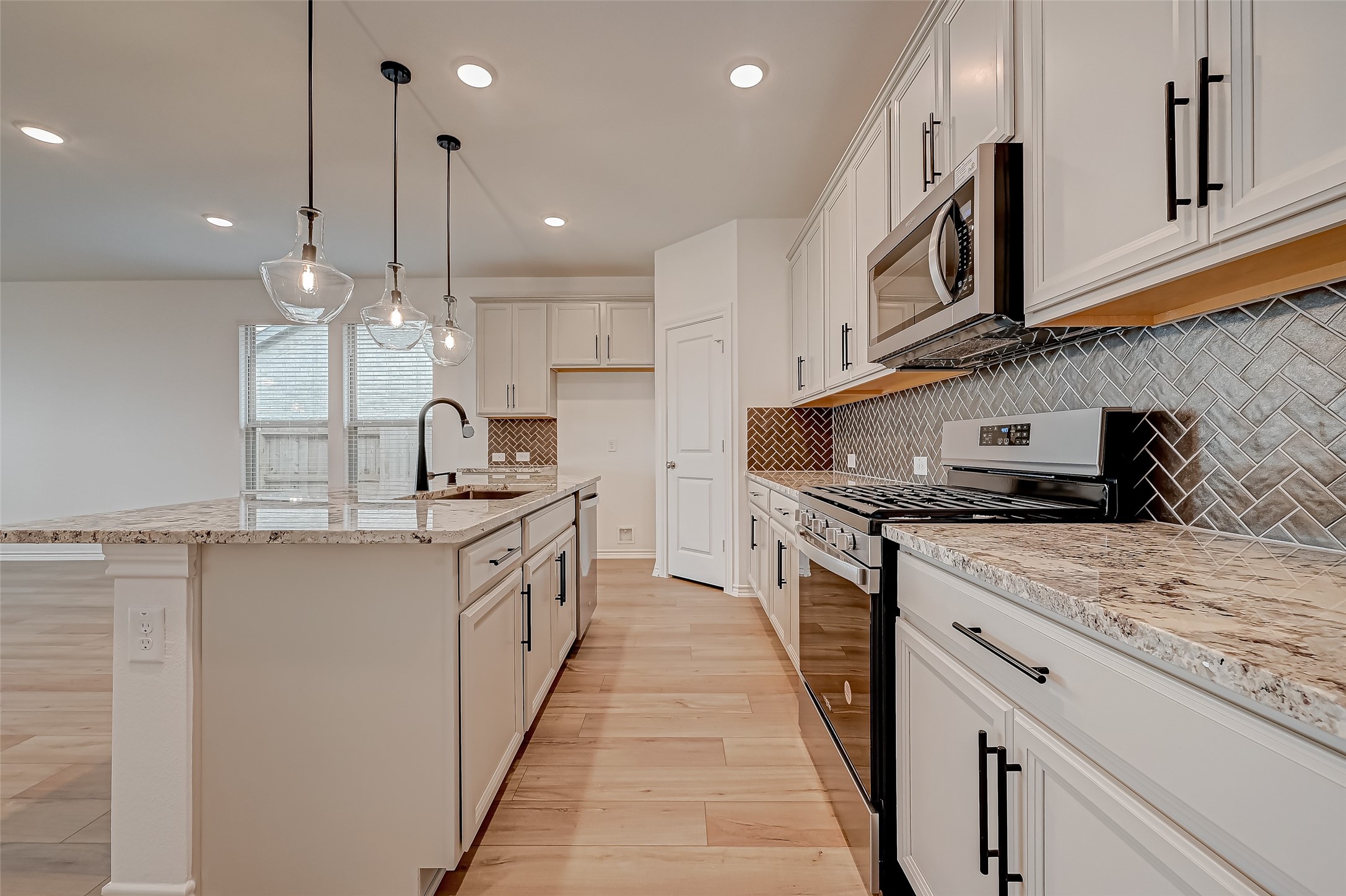 1308 Tan Gable Lane Katy, TX 77493 - Photo 10 of 30 a kitchen with stainless steel appliances granite countertop a sink a stove and a refrigerator
