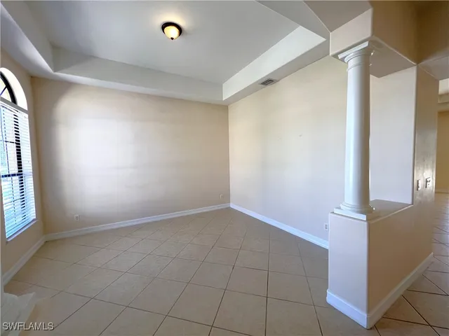 an empty room with windows and entrance