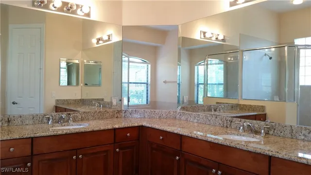 a bathroom with double sink and a mirror
