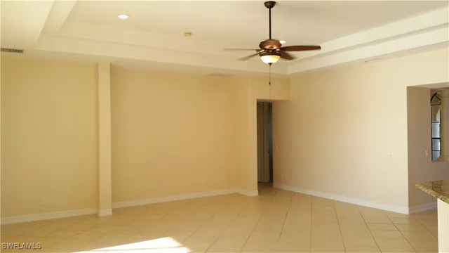 a view of a chandelier fan and refrigerator