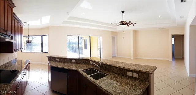 a kitchen with a stove kitchen island and stainless steel appliances