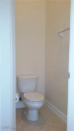 a white toilet sitting next to a shower