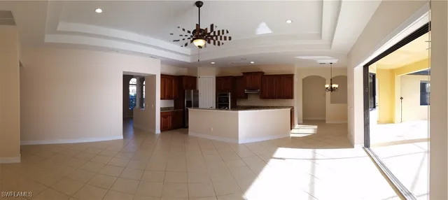 a view of a big room with chandelier and windows