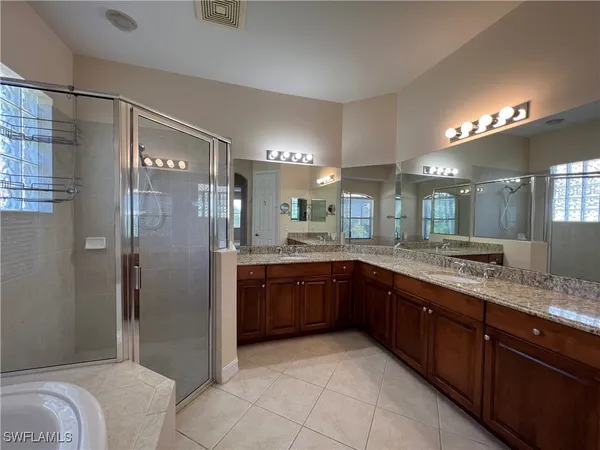 a large bathroom with a granite countertop sink mirror and shower