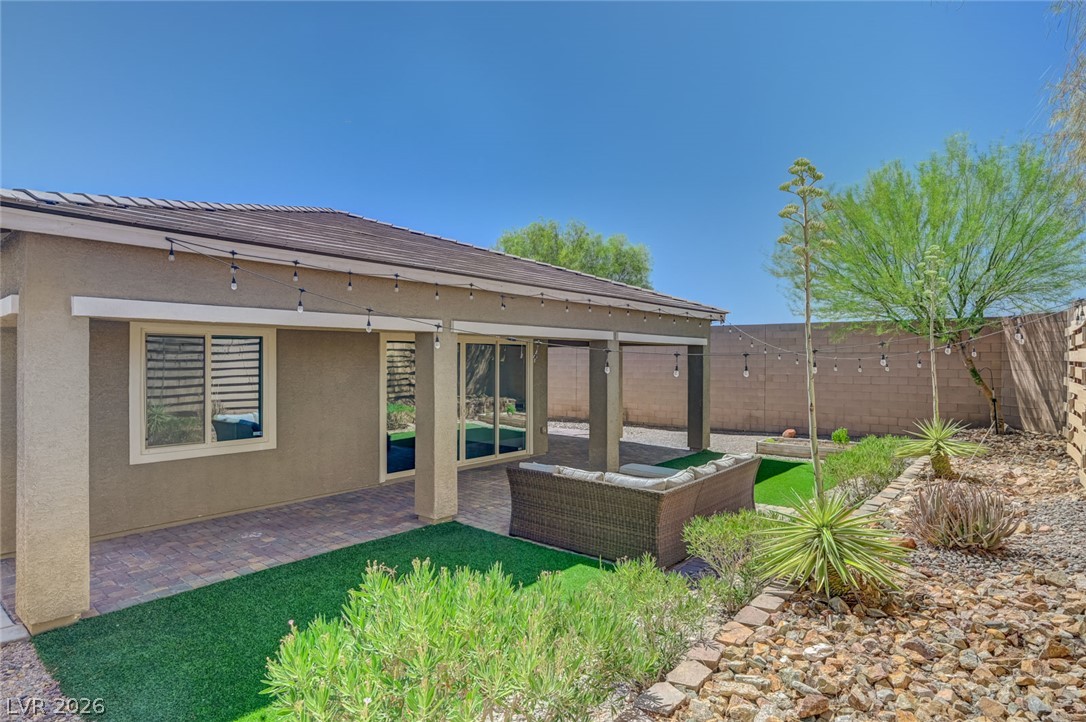 8197 Riley Love Street Las Vegas, NV 89139 - Photo 44 of 48 A private outdoor space with covered patio and low-maintenance landscaping for relaxed desert living.