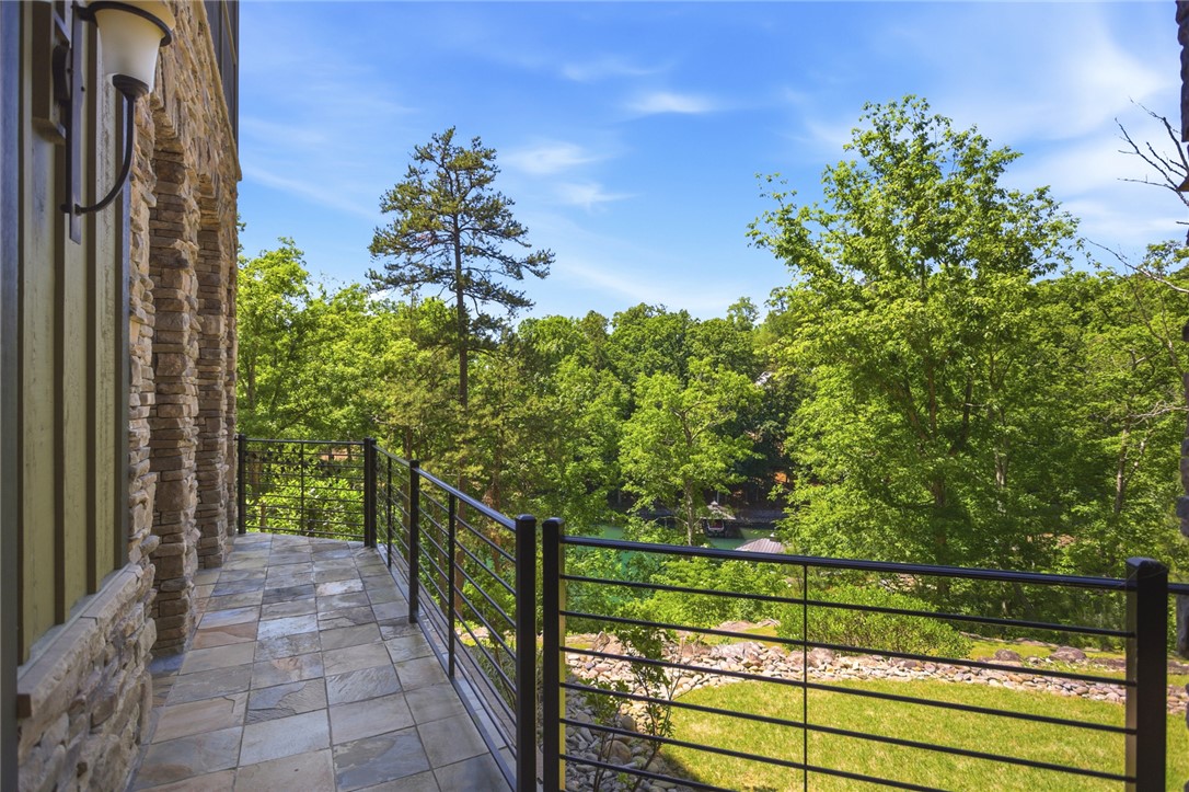 130 River Ridge Road Sunset, SC 29685 - Photo 36 of 47 Enjoy tranquil water views from this expansive, stone-clad balcony, offering a serene outdoor retreat.