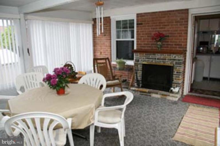 4119 Raleigh Road Pikesville, MD 21208 - Photo 11 of 15 a view of a dining room with furniture window and wooden floor