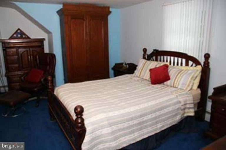 4119 Raleigh Road Pikesville, MD 21208 - Photo 12 of 15 a bedroom with a bed and a window