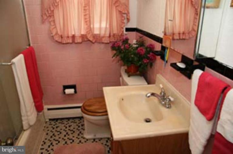 4119 Raleigh Road Pikesville, MD 21208 - Photo 13 of 15 a bathroom with a sink and a toilet