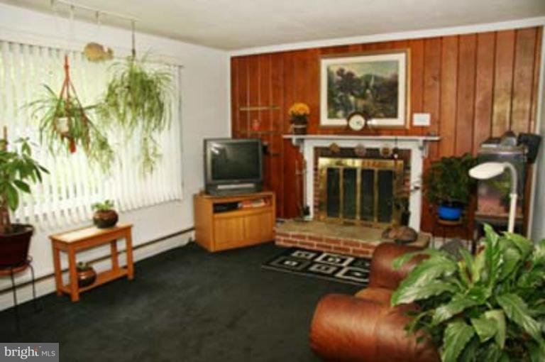 4119 Raleigh Road Pikesville, MD 21208 - Photo 14 of 15 a living room with furniture and a flat screen tv