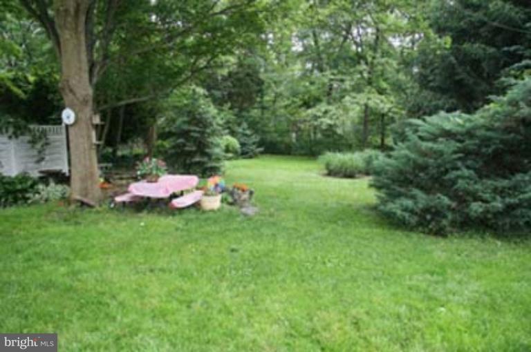 4119 Raleigh Road Pikesville, MD 21208 - Photo 4 of 15 a backyard of a house with a table and chairs